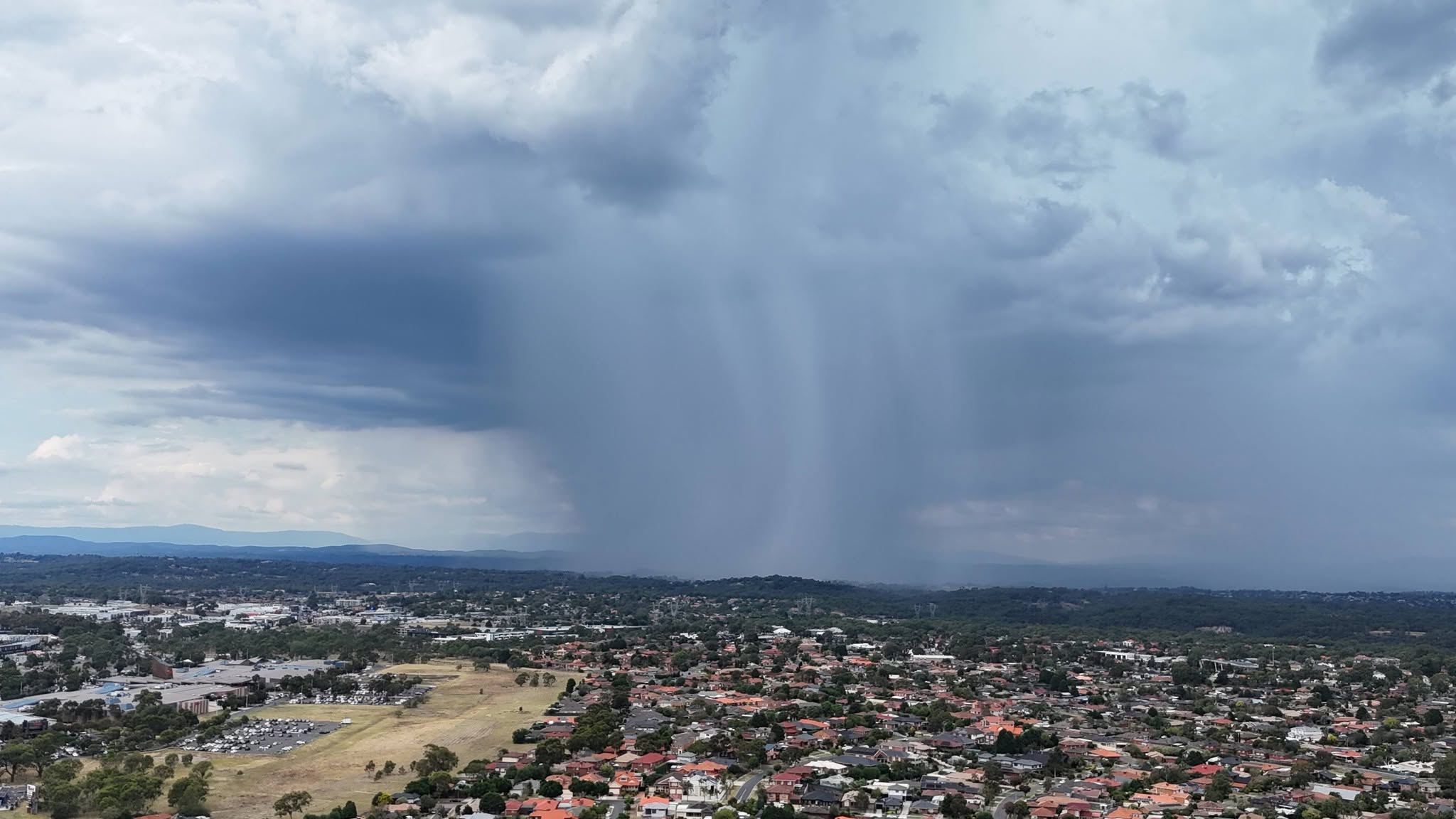 Aerial view of a rain shaft over an urban landscape captured from the air
